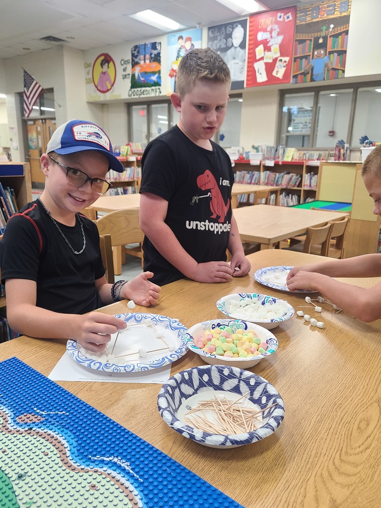 students building the Eiffel Tower with marshmallows and toothpicks