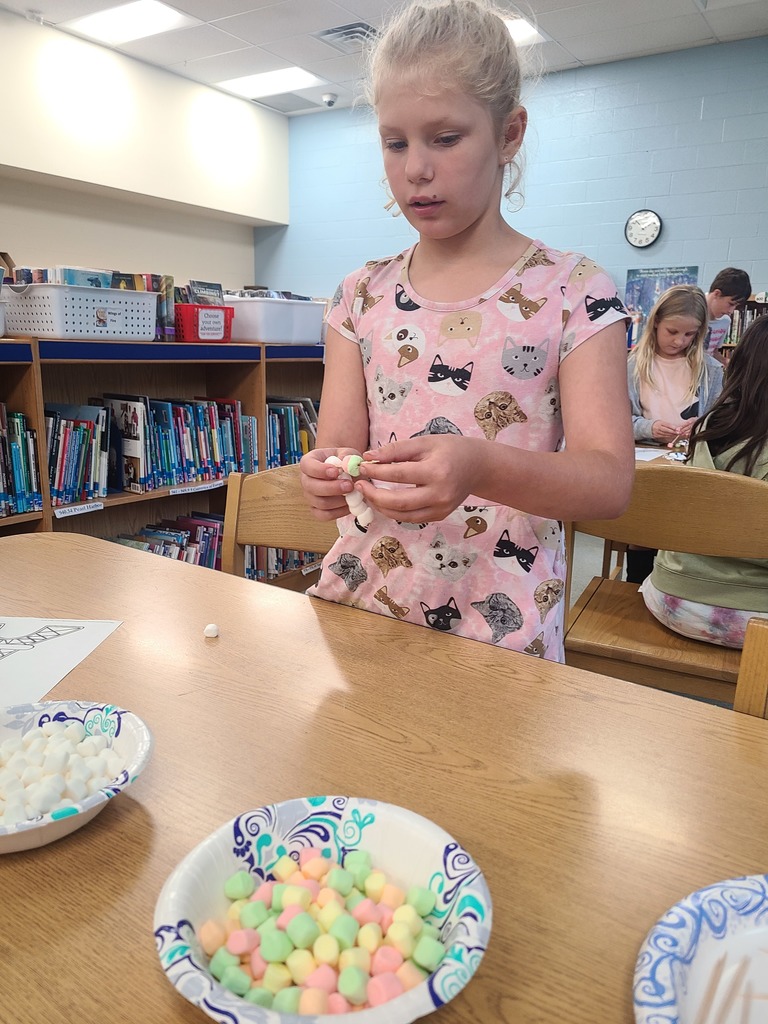 students building the Eiffel Tower with marshmallows and toothpicks